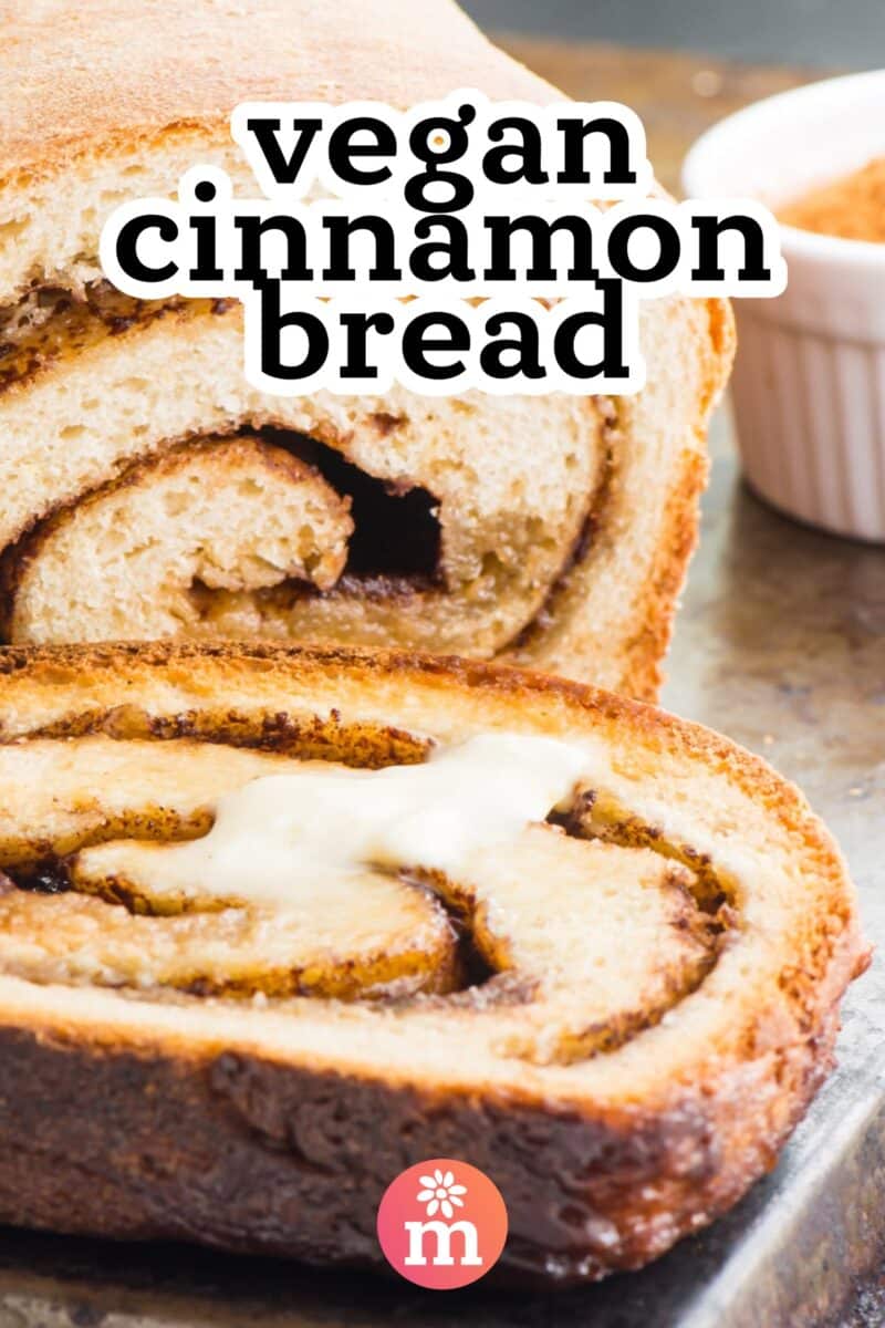 A slice of cinnamon bread sits in front of the rest of the loaf. The text reads, vegan cinnamon bread.