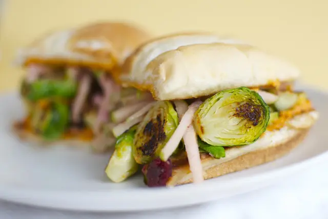 A Brussels Sprout Sandwich with Apple Slaw and Red Pepper Hummus.