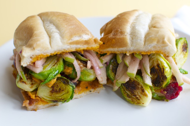 Two halves of the brussels sprouts sandwich showing ingredients