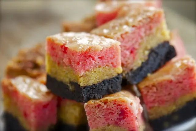 Neapolitan Gooey Dessert Bars lined up on a plate