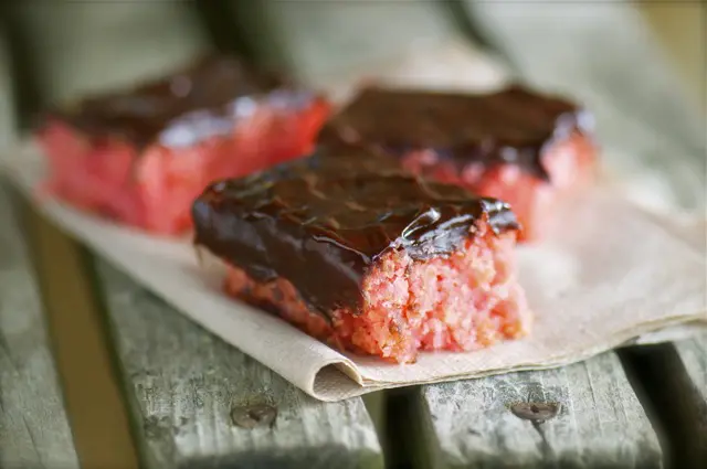Chocolate Covered Strawberry Cake is shown here with three slices ready to be eaten.