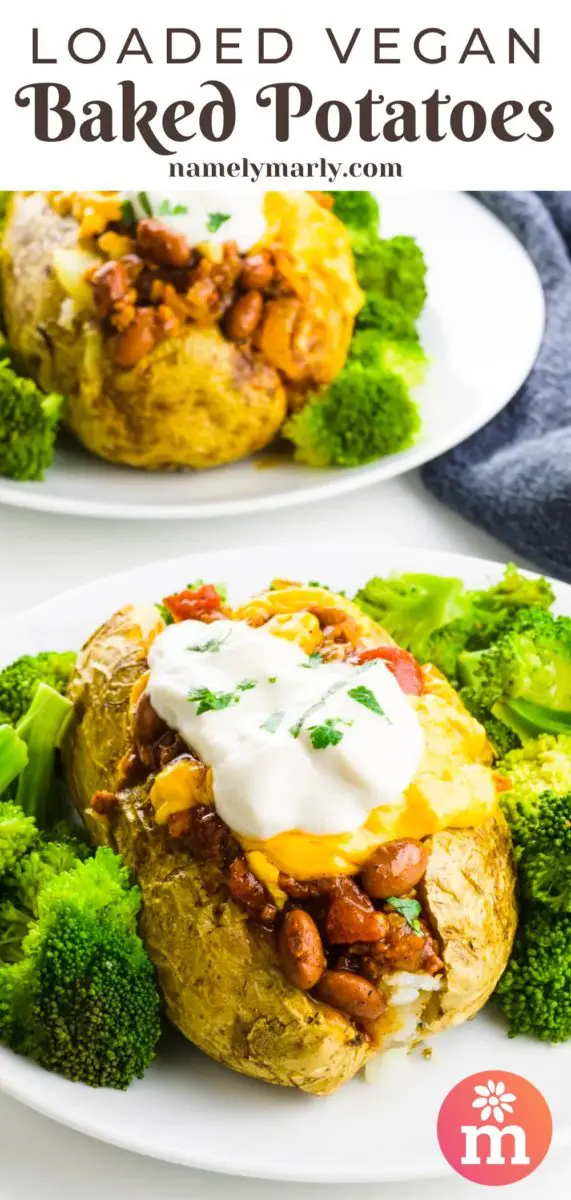A baked potato sits on a plate with broccoli around it. The potato has lots of toppings like chili and sour cream. There's another potato just like it in the background sitting by a blue kitchen towel. The text at the top of the page reads, Loaded Vegan Baked Potatoes.