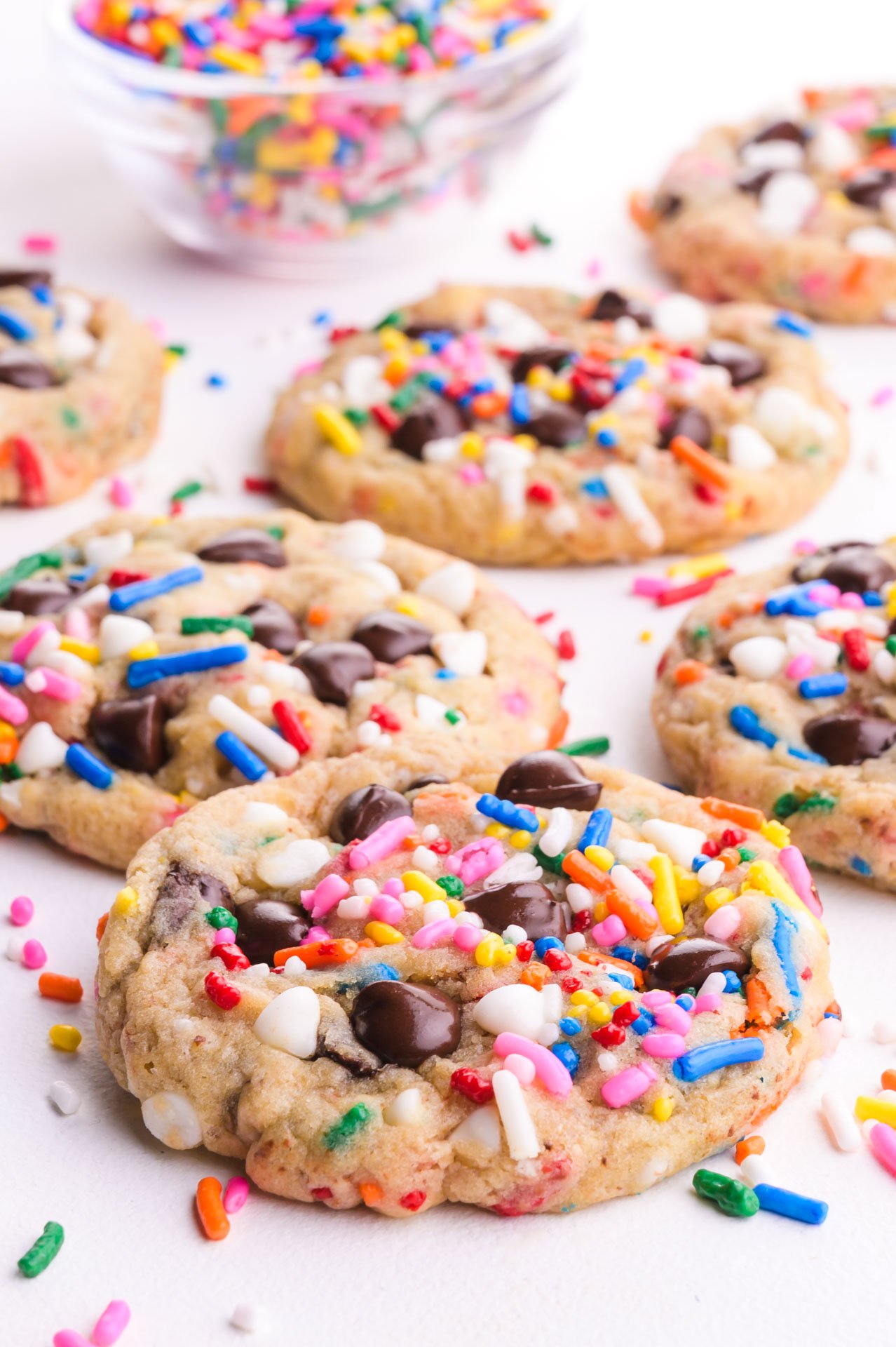 Vegan Chocolate Chip Sprinkle Cookies with colorful sprinkles scattered around.