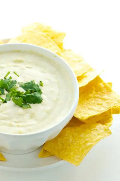 Vegan Cheese Dip is surrounded by tortilla chips and ready to serve