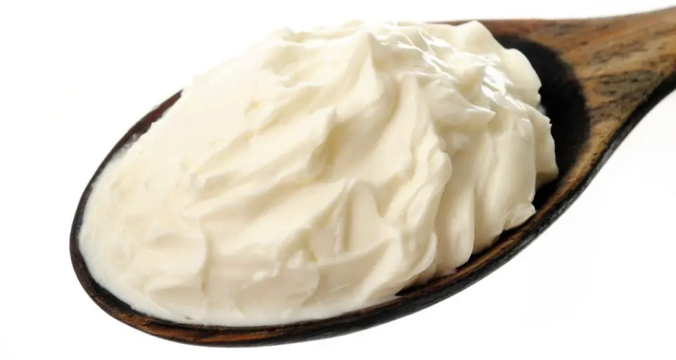 A wooden spoon holds cream cheese in the middle.