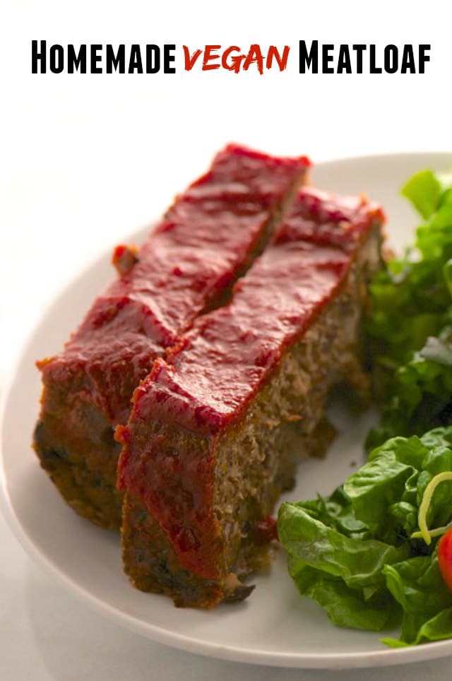 Two slices of meatloaf are topped with red sauce. They sit on a plate next to a salad. The text at the top reads: Homemade Vegan Meatloaf.