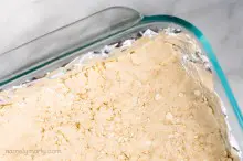 The crust is pressed into the bottom of a baking dish for lemon bars.