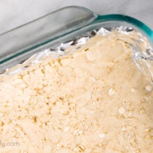 The crust is pressed into the bottom of a baking dish for lemon bars.