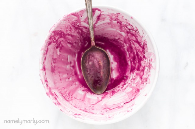 Blueberry Sauce stains a white bowl after making Vegan Blueberry Pie Bars