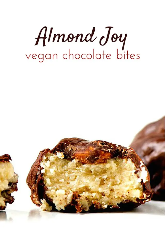 A chocolate coated coconut candy with a bite taken out is on a white counter. The words, "Almond Joy Chocolate Bites" is at the top.