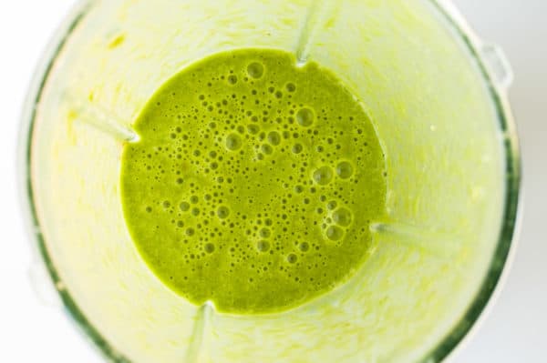 Looking into a blender with Green Smoothie mixture at bottom