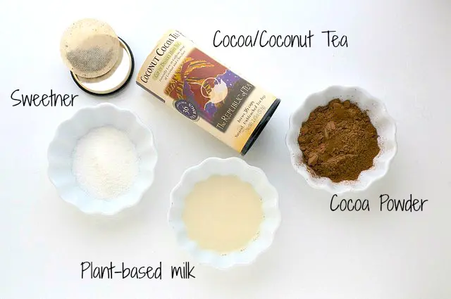 Looking down on the ingredients for this tea-infused hot cocoa, including cocoa powder, plant-based milk, and more.
