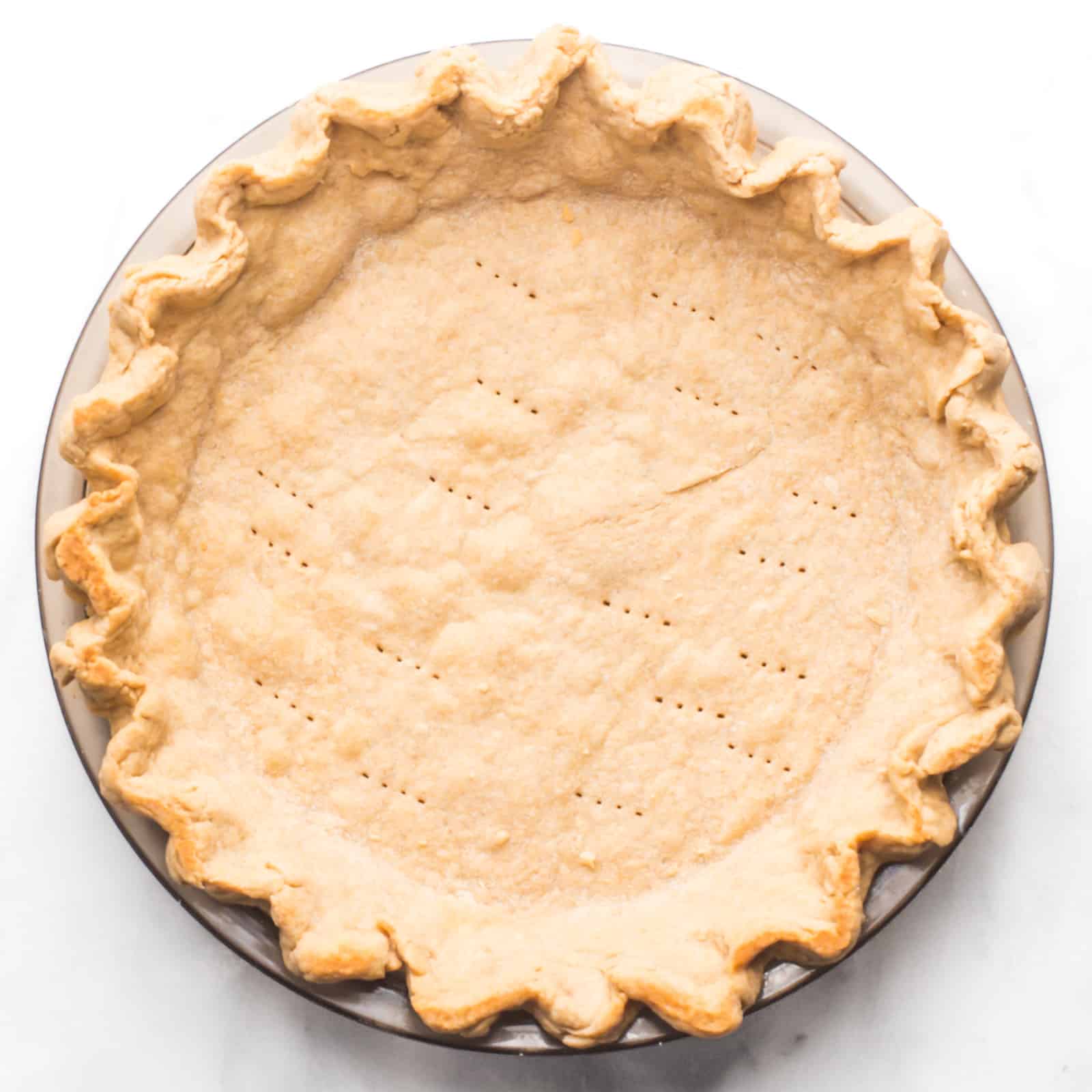 A pie crust fresh from the oven with the fluted edges nicely golden.