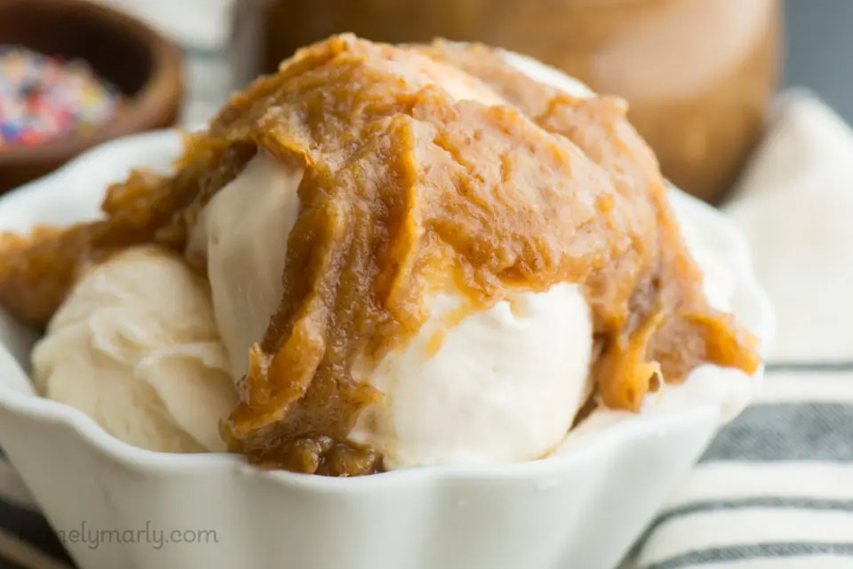 A close-up of sauce drizzled over ice cream.