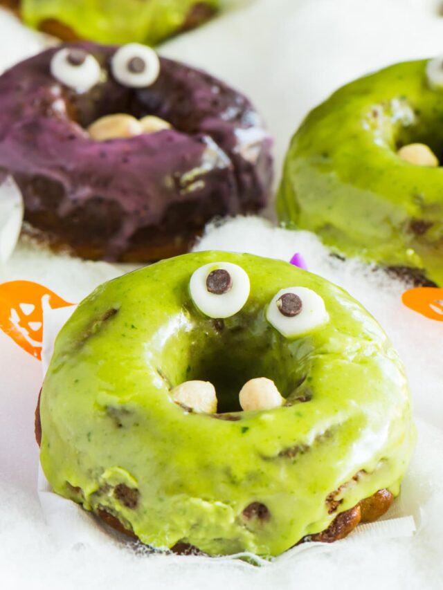 Purple and green donuts with googly eyes for Halloween.