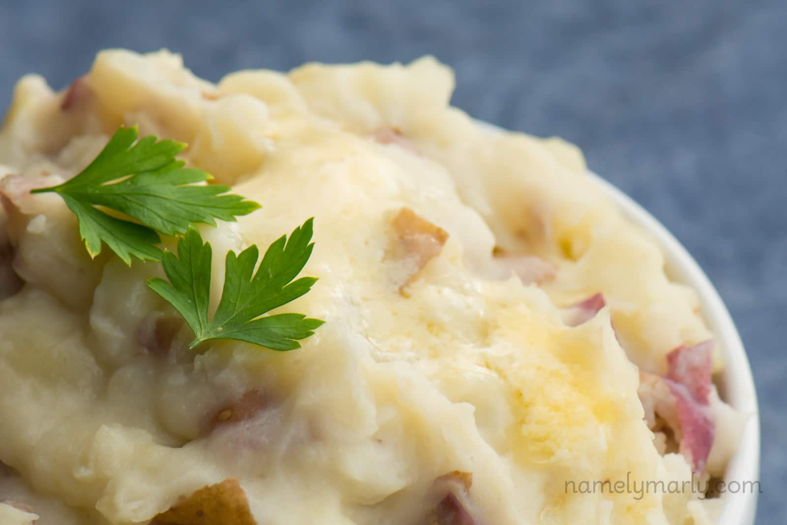 A mound of Vegan Chunky Garlic Mashed Potatoes with parsley on top.