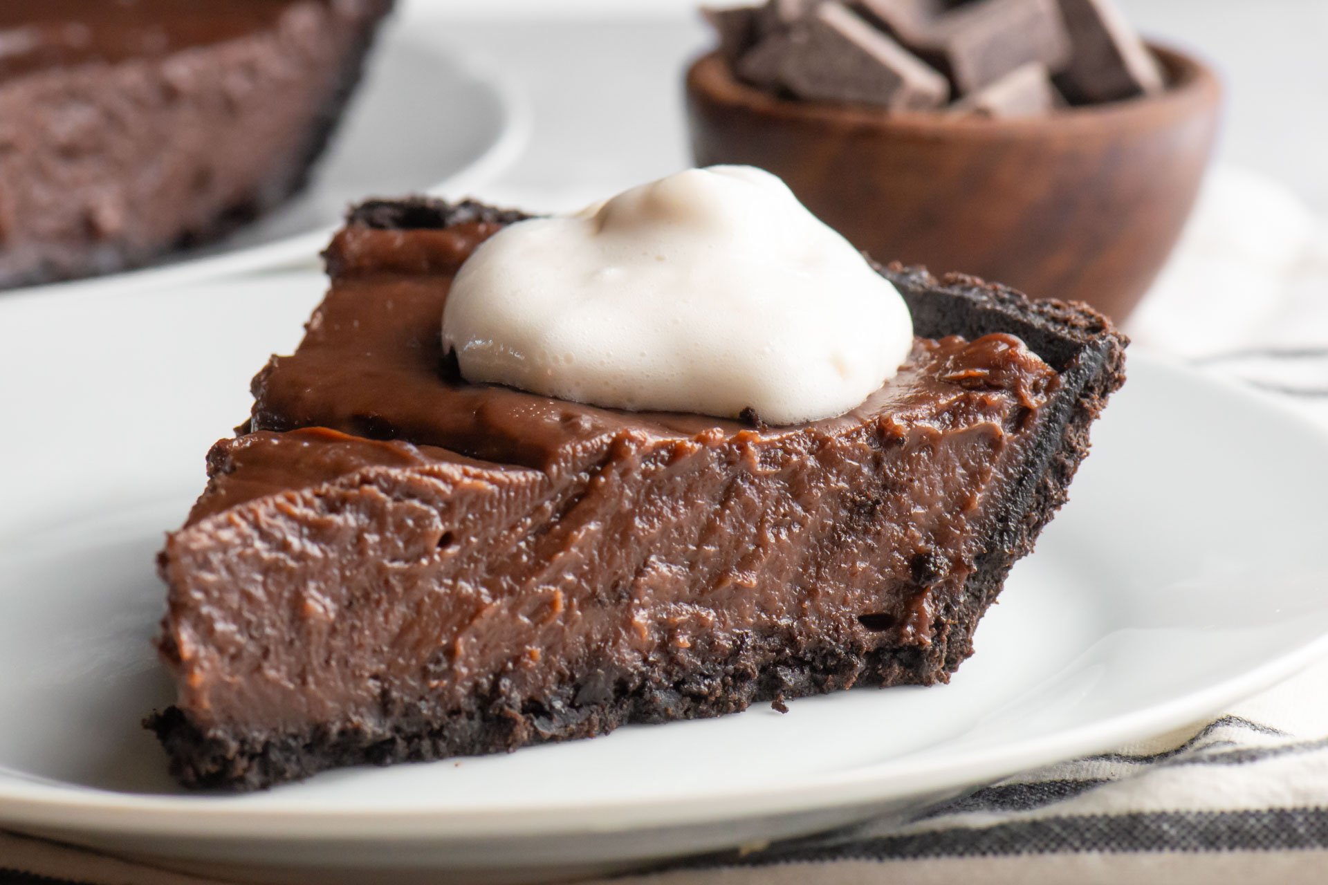 A slice of easy vegan chocolate peanut butter pie on a white plate.