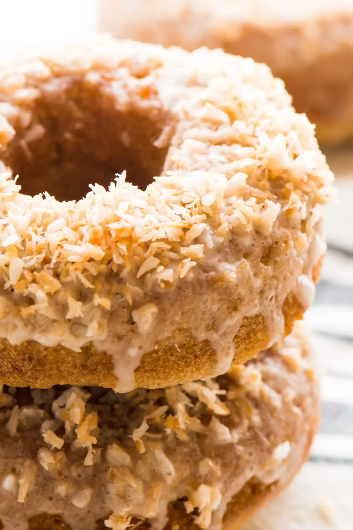 A closeup of a stack of coconut donuts.