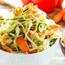 Spicy Vegan Pad Thai Zucchini Noodles are drizzled in a spicy, tangy sauce and topped with chopped peanuts.