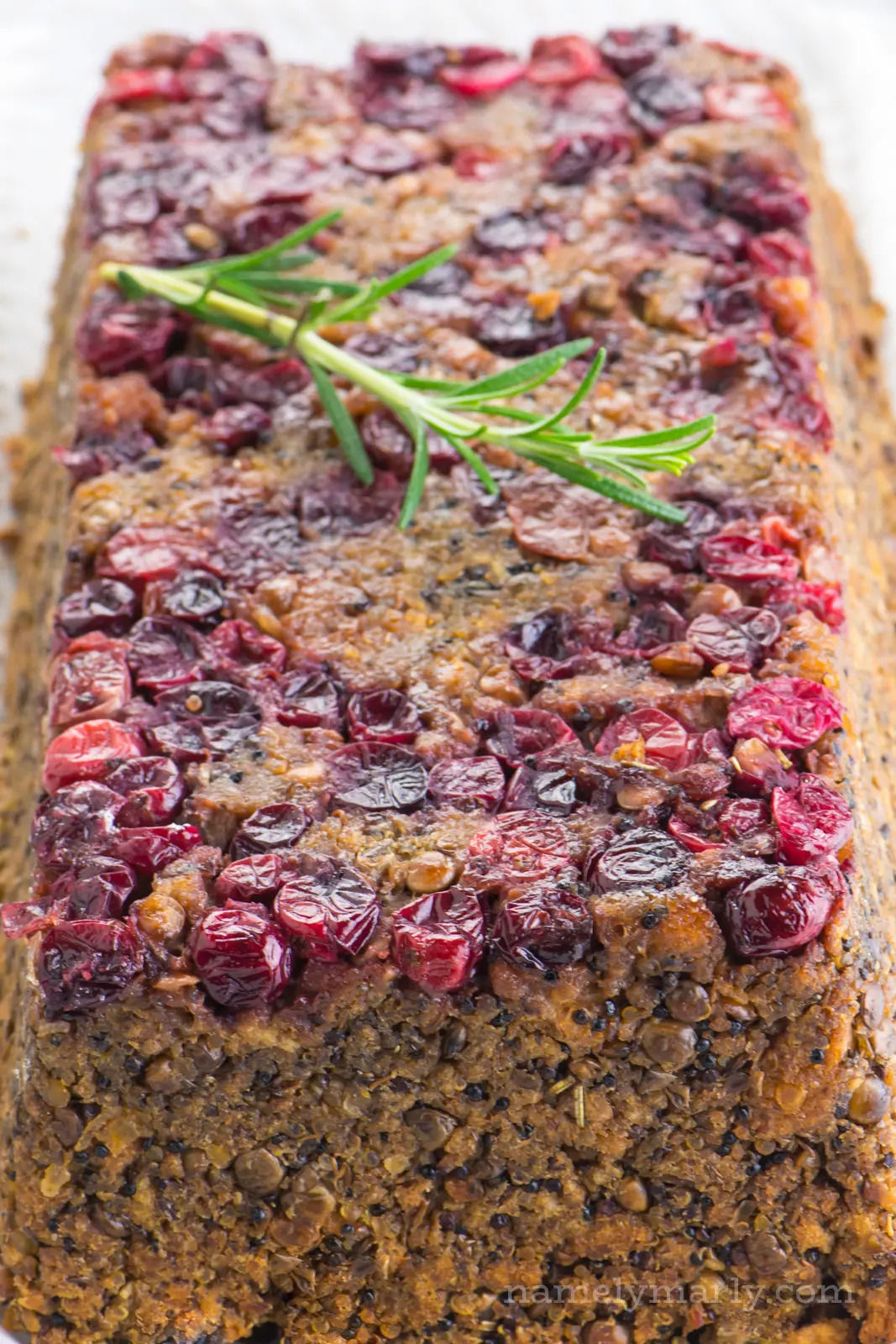 A view of the top of holiday lentil loaf showing the layer of cranberries on top.