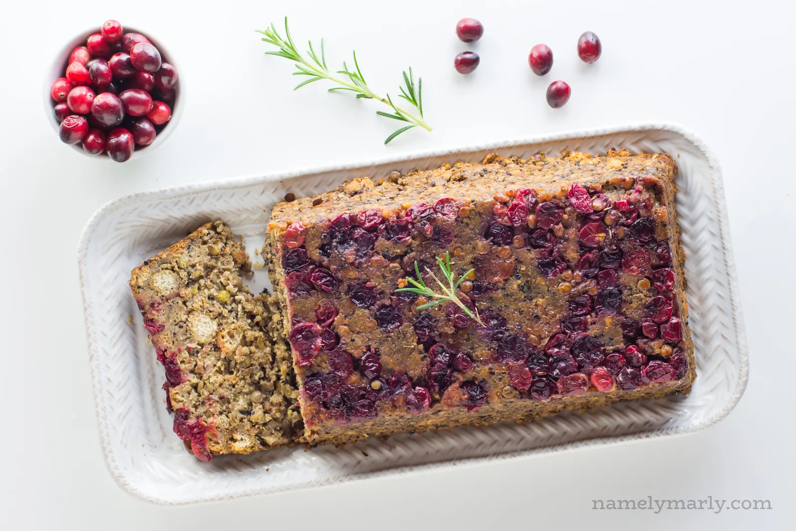 Overhead view of Vegan Holiday Lentil Loaf with stuffing and cranberries