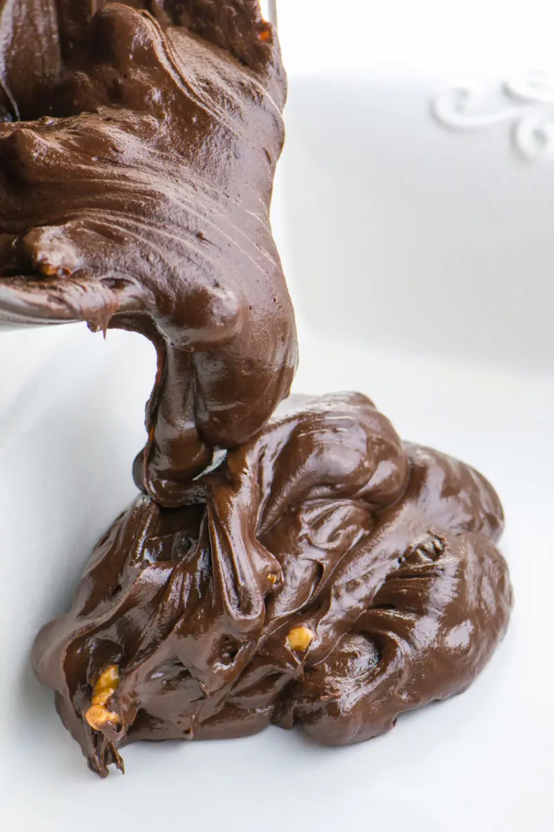 A chocolate fudge batter is being poured into a dish.
