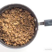 Cooked lentils in a saucepan.
