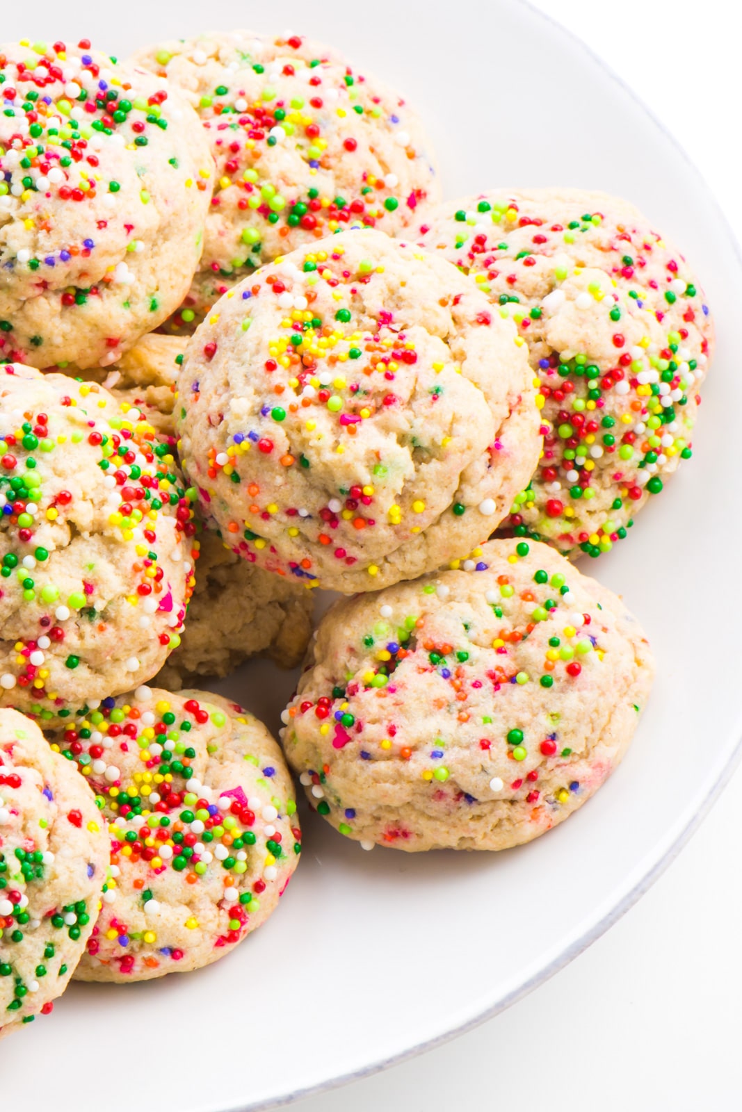 Several colorful confetti cookies on a plate.