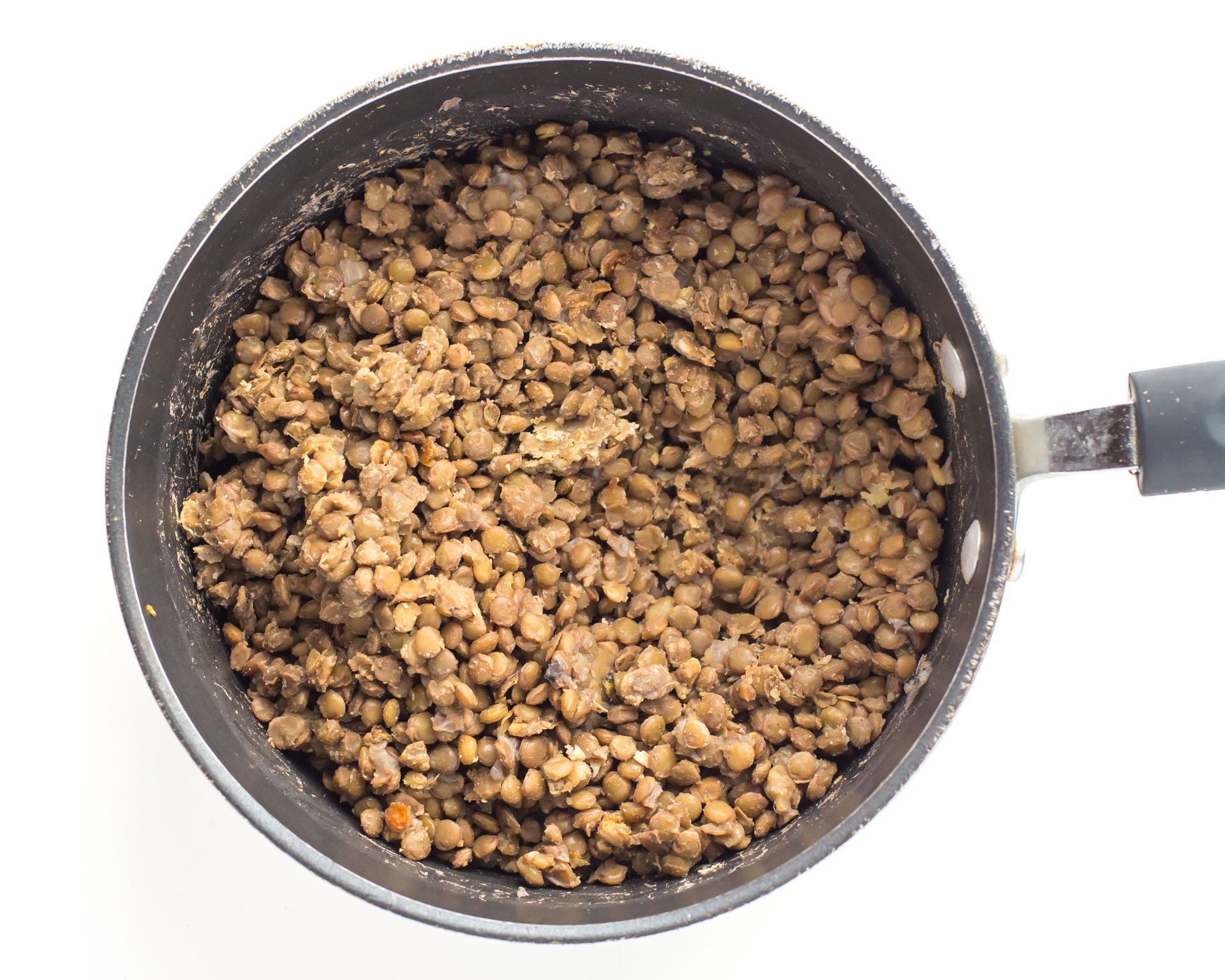 Cooked lentils in a saucepan.