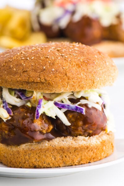 A close-up of lentil BBQ meatball sandwich another sandwich is behind it.