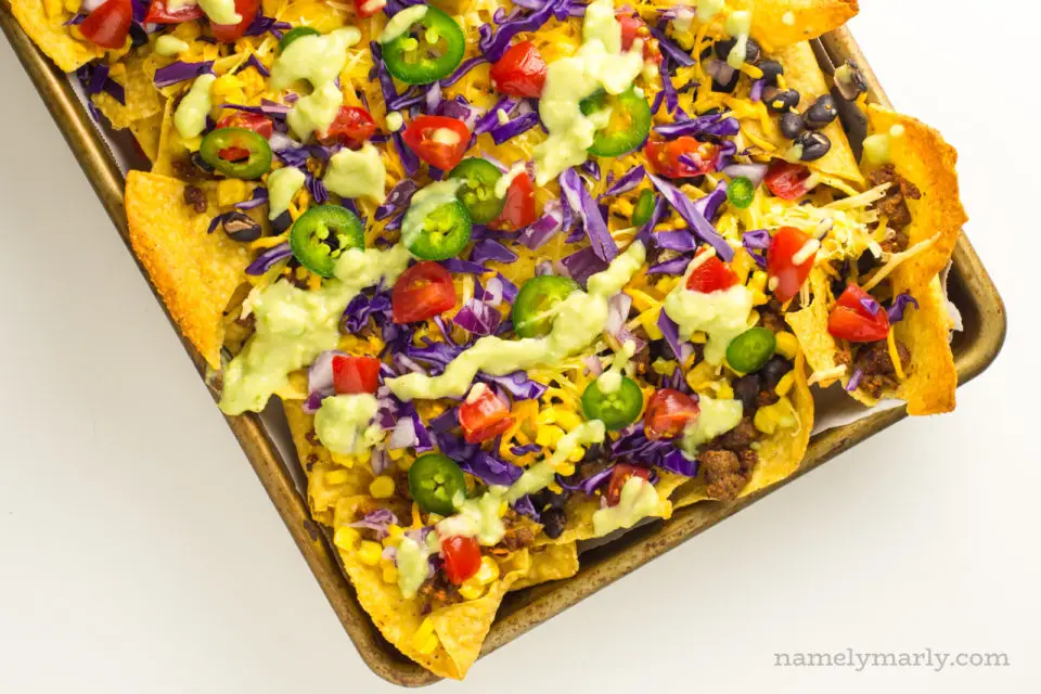 A baking sheet is loaded with baked vegan nachos.