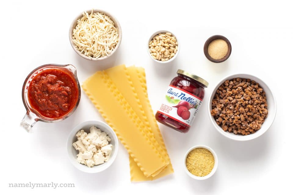 All the ingredients for veggie pasta dish, including red sauce, noodles, and more.