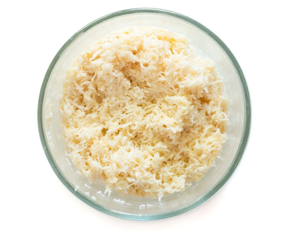 A bowl of coconut macaroon cookie dough in a bowl.