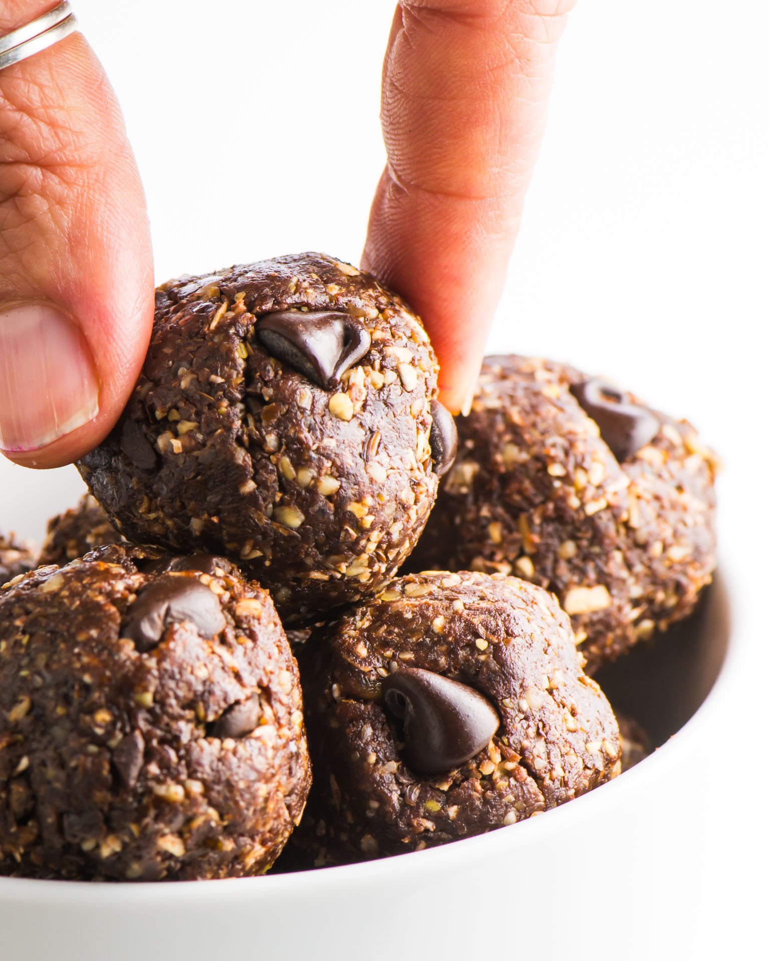 A hand reaches in and grabs an energy ball from the top of the pile.