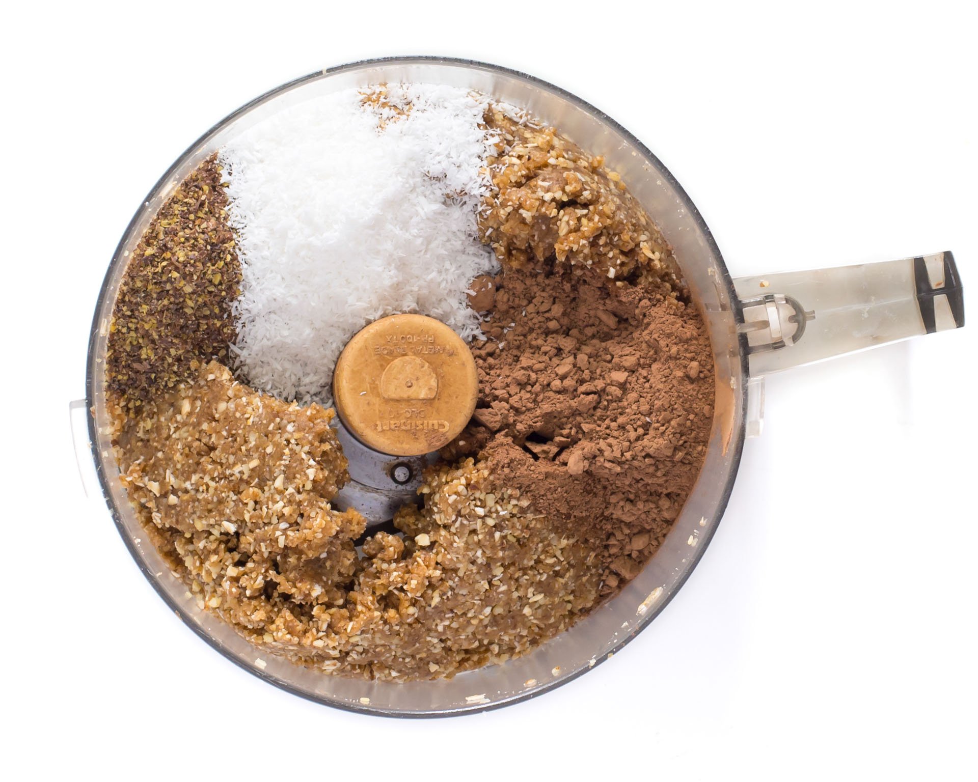 Other ingredients, like coconut flakes, are added to the pulsed energy bite batter.