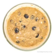 Batter with blueberries is in a glass bowl.