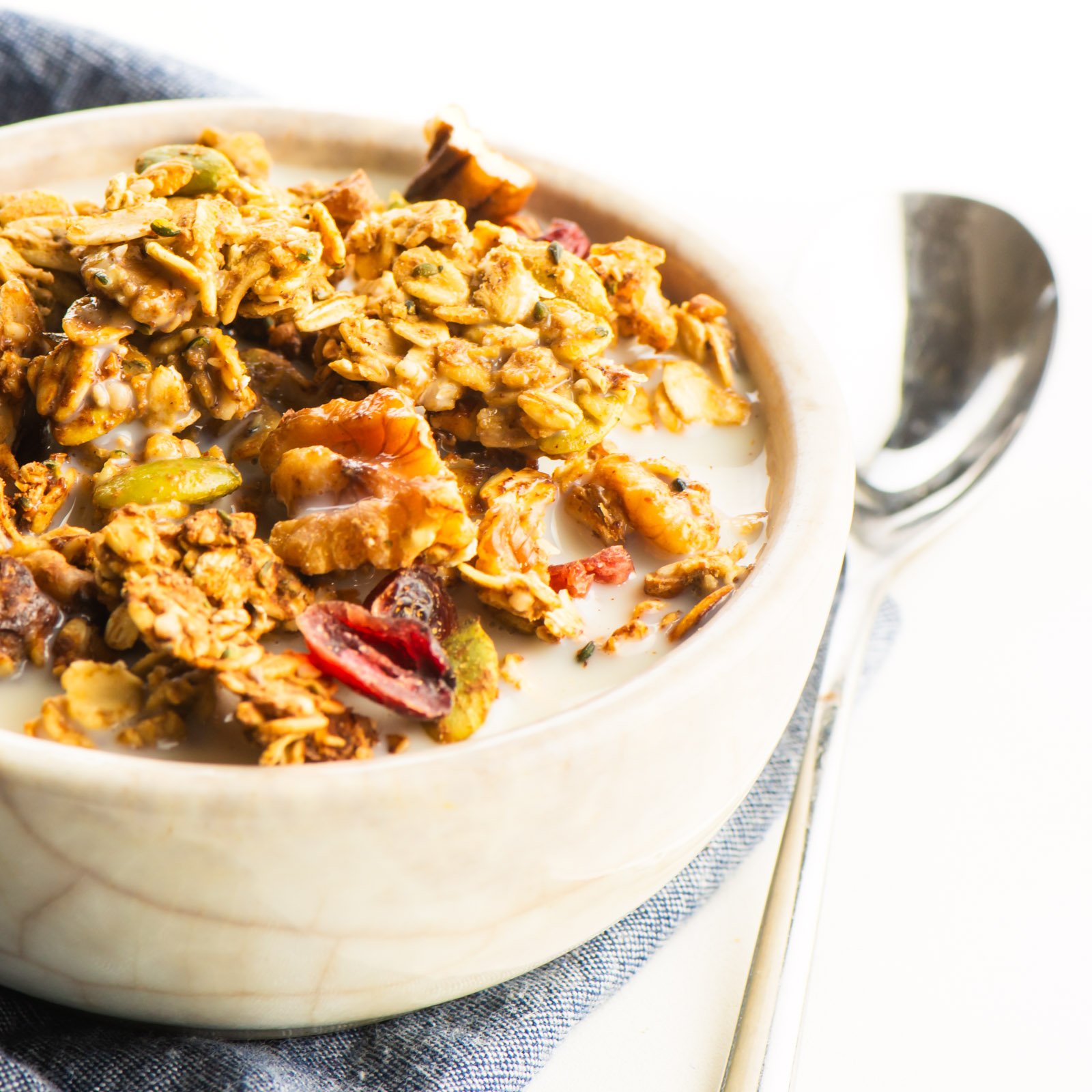 A bowl full of cereal with milk.