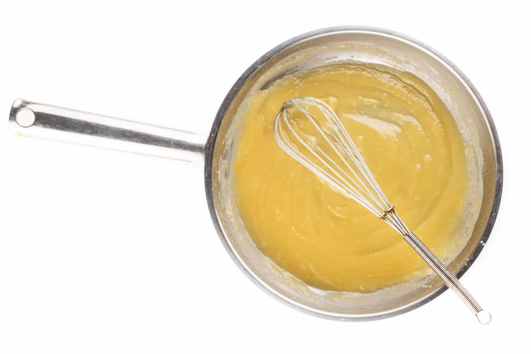 Vegan butter is melted in a skillet and flour is added to make a roux.