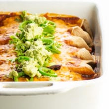 A baking dish full of vegan enchiladas fresh from the oven.