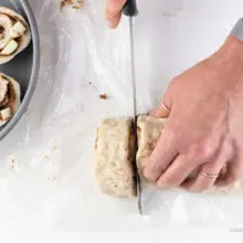 Using a serrated knife to cut cinnamon rolls.