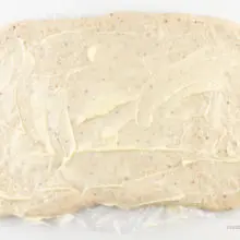Vegan butter has been spread over dough rolled out in a rectangle.