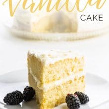A slice of layered vegan vanilla cake has blackberries sitting next to it. The text above it reads: Vegan Vanilla Cake.