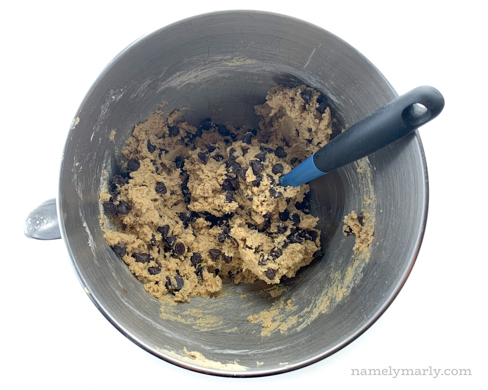 chocolate chip cookie dough in a stainless steel mixing bowl
