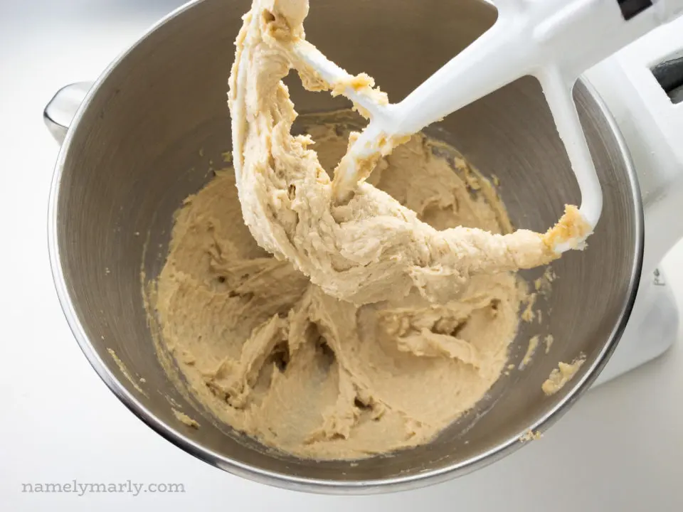 Looking at a beater full of creamy vegan butter and sugar whipped together in a stand mixer.