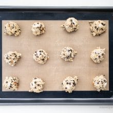 Looking down on a baking sheet with cookie dough balls ready to be baked.