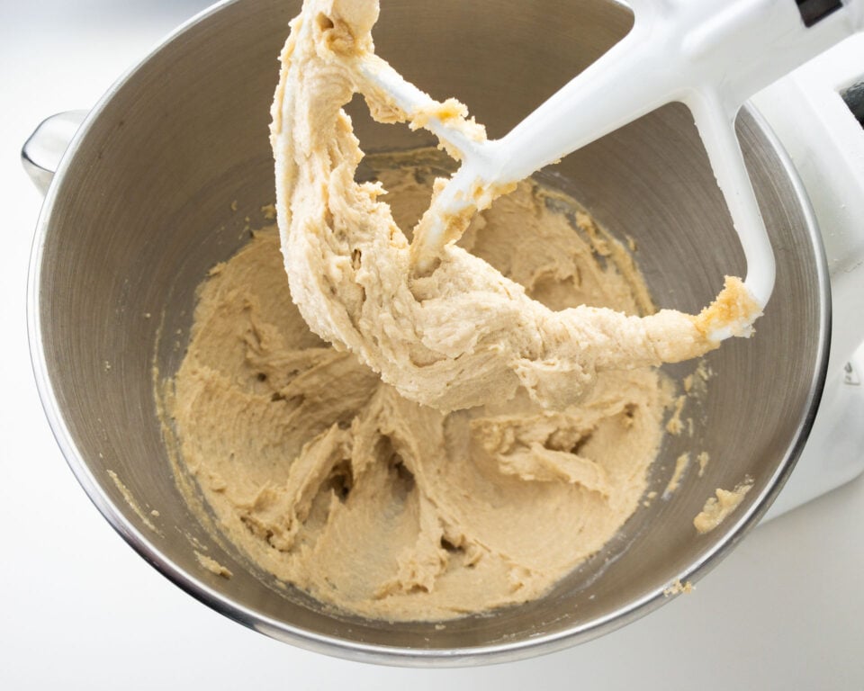 Looking at a beater full of creamy vegan butter and sugar whipped together in a stand mixer.