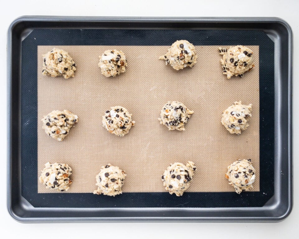 Looking down on a baking sheet with cookie dough balls ready to be baked.