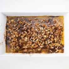 Chopped pecans on top of an unbaked cake.