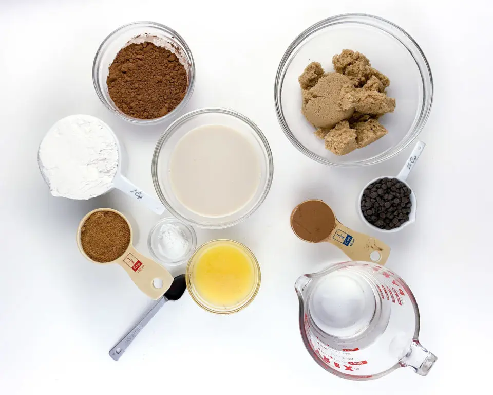 The ingredients to make a dessert recipe are laid out in bowls and measuring cups.