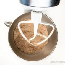 Flour and cocoa powder have been mixed in a mixing bowl in a stand mixer.